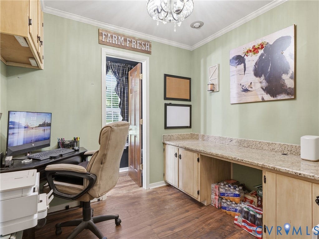 6723 Bull Hill Road, Prince George, VA 23875 Built-in cabinetry with stone-finish countertops, wood-finish flooring, and crown molding under a decorative multi-light chandelier