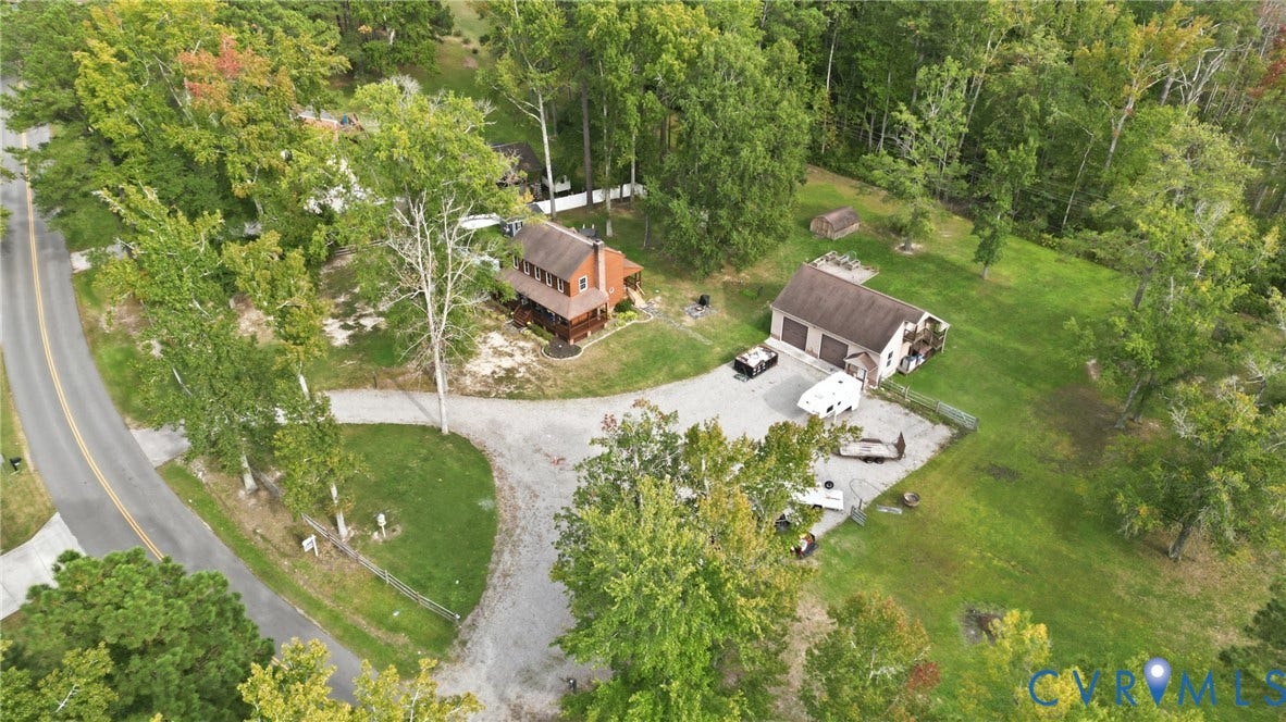 6723 Bull Hill Road, Prince George, VA 23875 Wooded lot with a gravel driveway, a two-story residence featuring a porch, and an additional garage structure