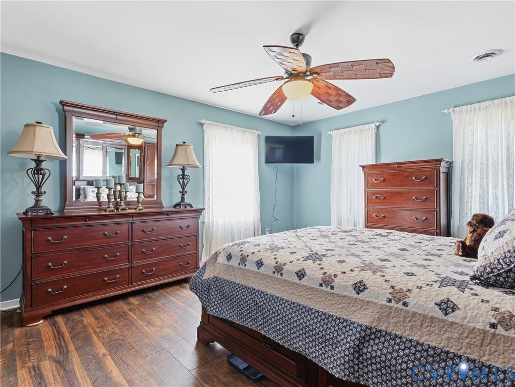 6723 Bull Hill Road, Prince George, VA 23875 Wood-finish flooring, multi-pane windows with window treatments, and a central ceiling fan with integrated lighting