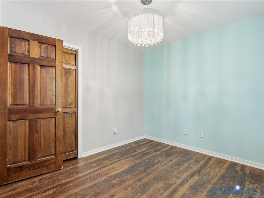 6723 Bull Hill Road, Prince George, VA 23875 Wood-finish flooring, six-panel wood door, and tiered crystal-style drum pendant lighting