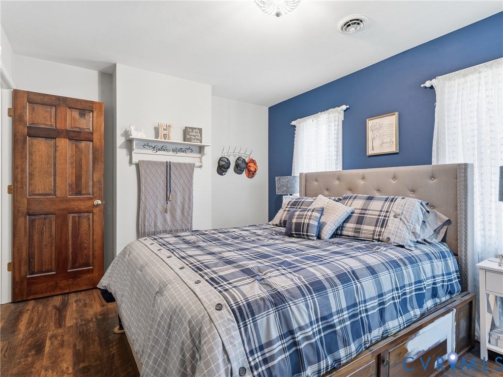 6723 Bull Hill Road, Prince George, VA 23875 Wood-finish flooring, six-panel solid wood door, and accent wall