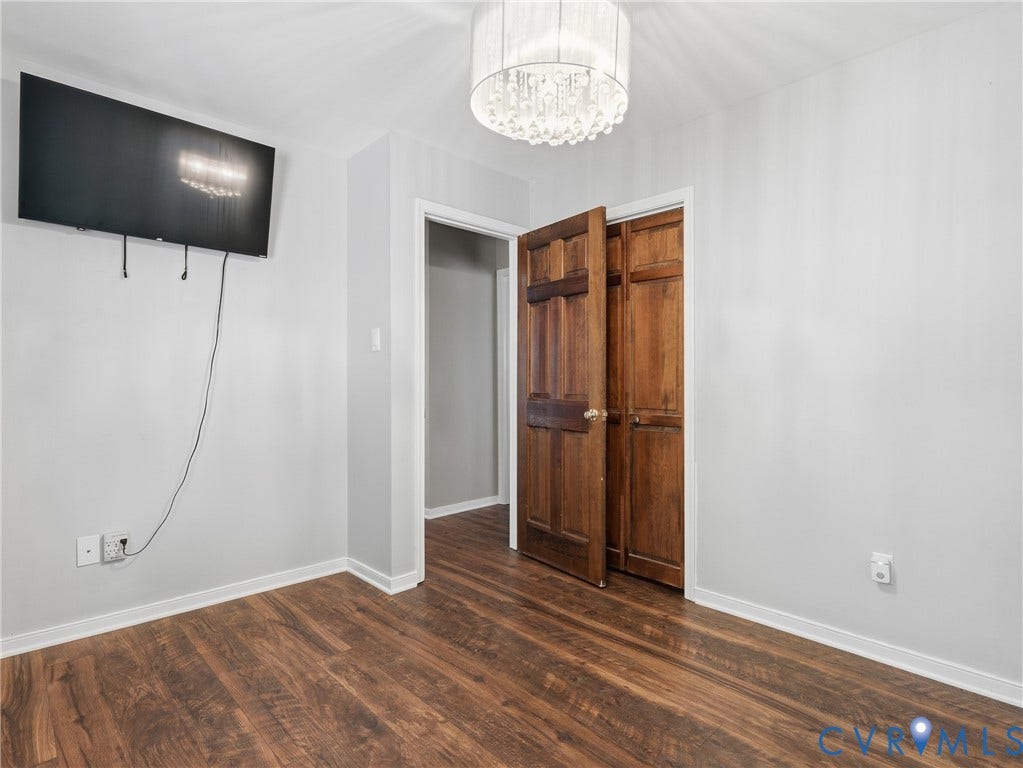6723 Bull Hill Road, Prince George, VA 23875 Wood-finish flooring, crystal drum pendant lighting, and six-panel natural wood doors