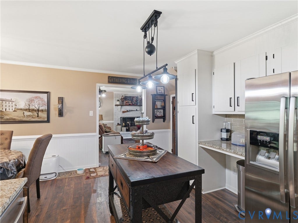 6723 Bull Hill Road, Prince George, VA 23875 Kitchen featuring white cabinetry, stone-finish countertops, stainless steel refrigerator, pulley-style overhead pendant lighting, and wood-finish flooring