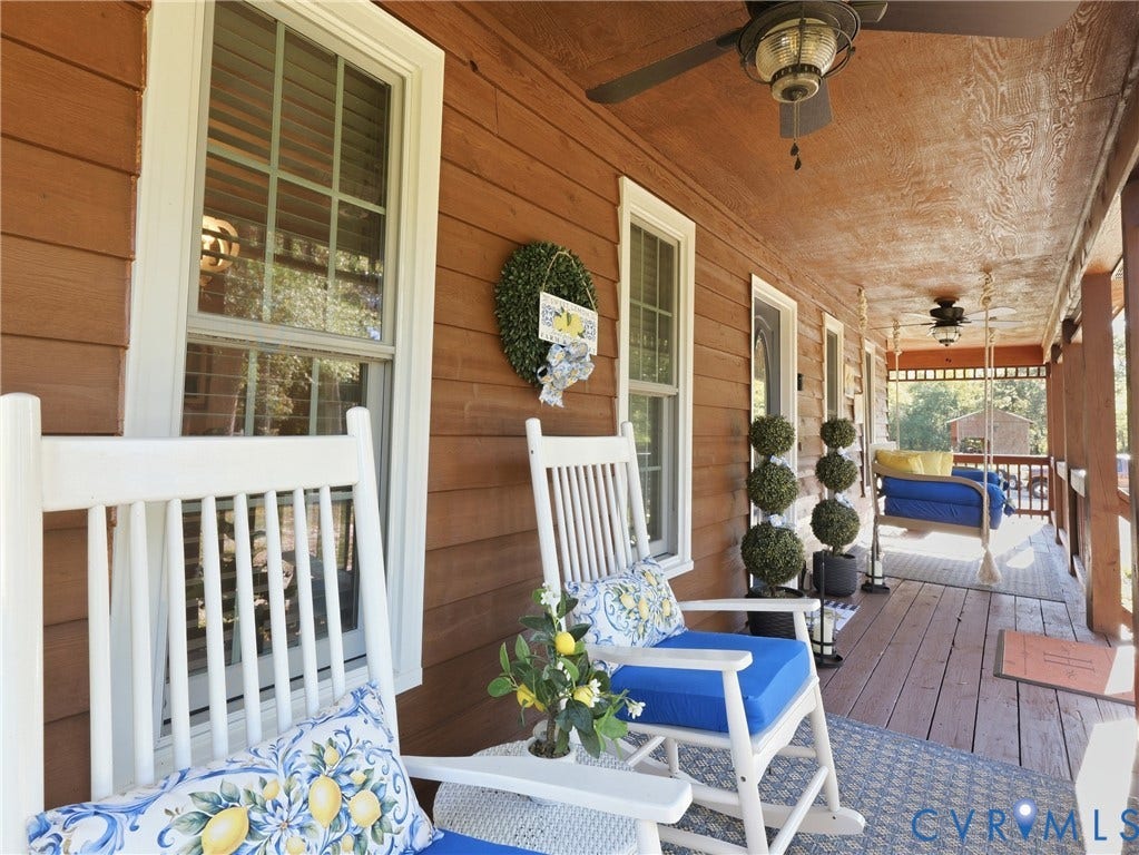 6723 Bull Hill Road, Prince George, VA 23875 Covered front porch featuring wood-plank siding, wood-finish flooring, and two ceiling-mounted fans
