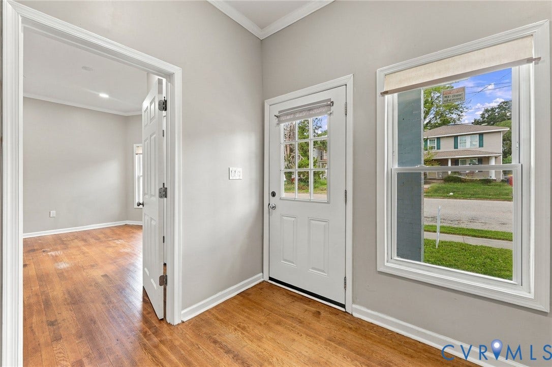 1432 Ferndale Avenue, Petersburg, VA 23803 Hardwood flooring, light gray wall finishes, white trim, and a white paneled door with glass inserts