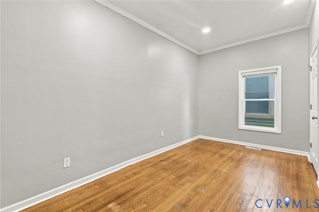 1432 Ferndale Avenue, Petersburg, VA 23803 Light gray painted walls with white crown molding, recessed lighting, wood-finish flooring, and a white framed window