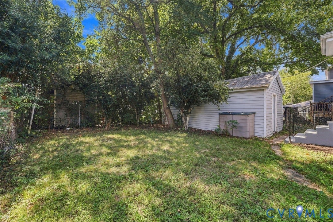 1432 Ferndale Avenue, Petersburg, VA 23803 Expansive rear yard featuring a detached storage shed, mature trees, and concrete steps
