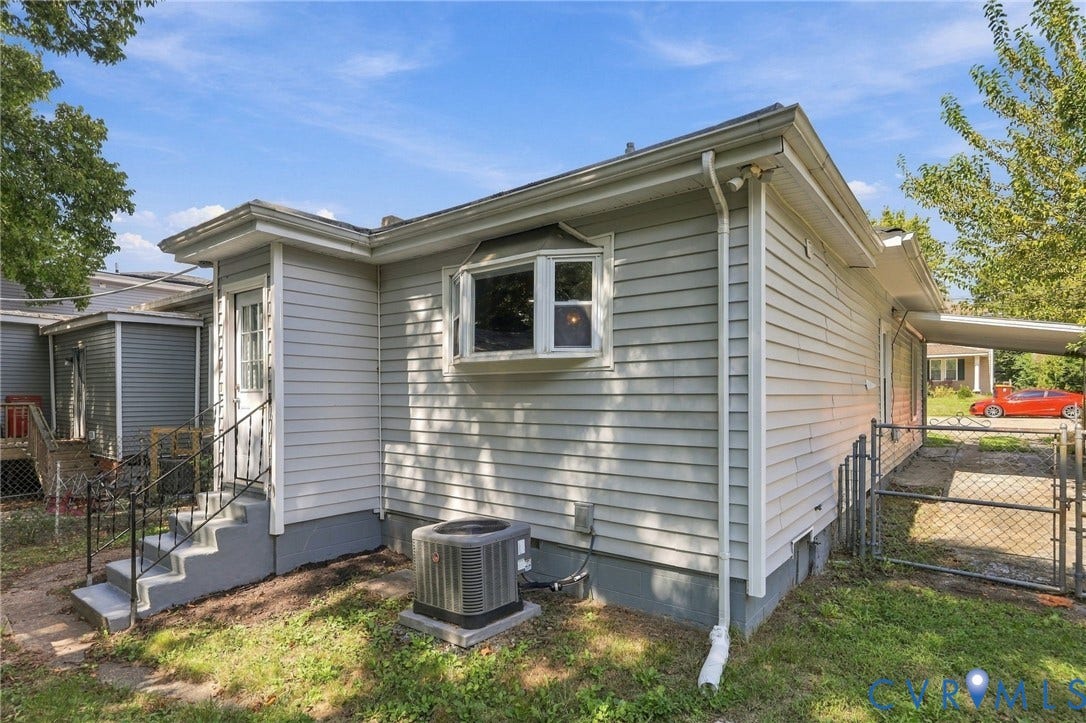 1432 Ferndale Avenue, Petersburg, VA 23803 Light gray horizontal siding with white trim, bay window, concrete steps with metal railing, and a fenced area
