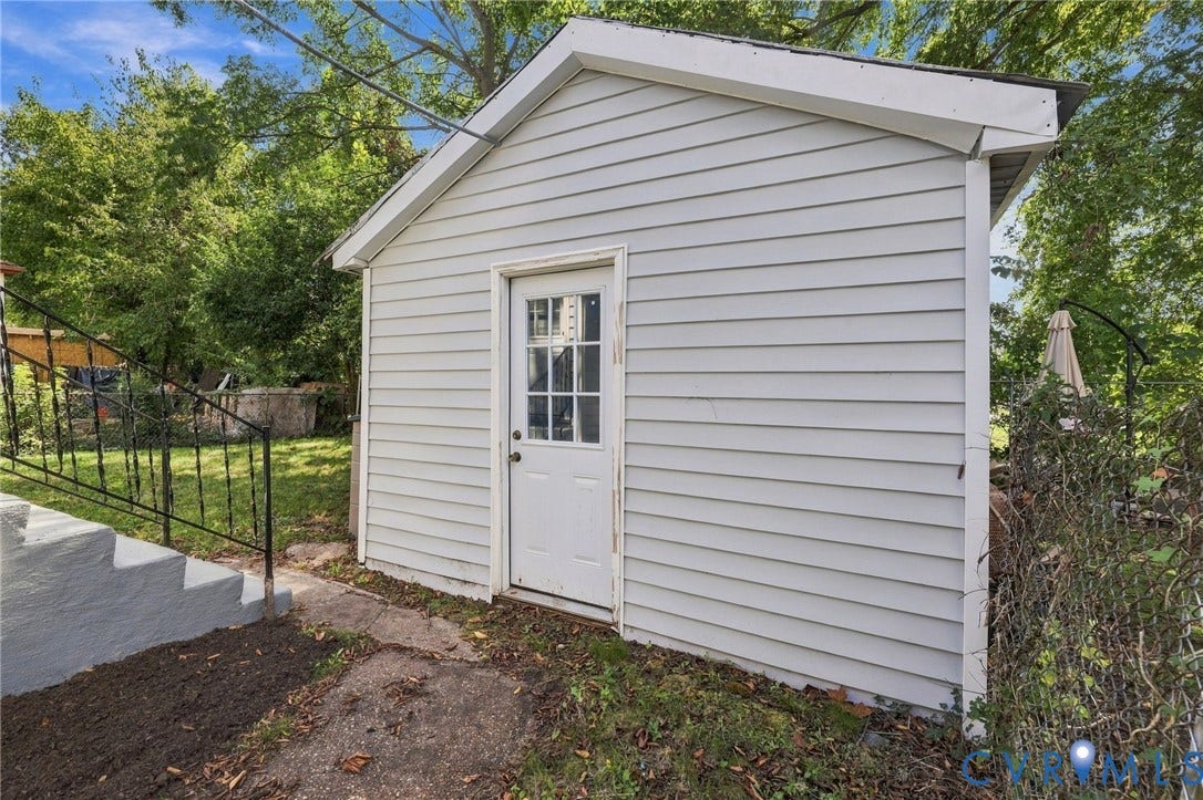 1432 Ferndale Avenue, Petersburg, VA 23803 Detached storage shed with horizontal siding and a paneled door