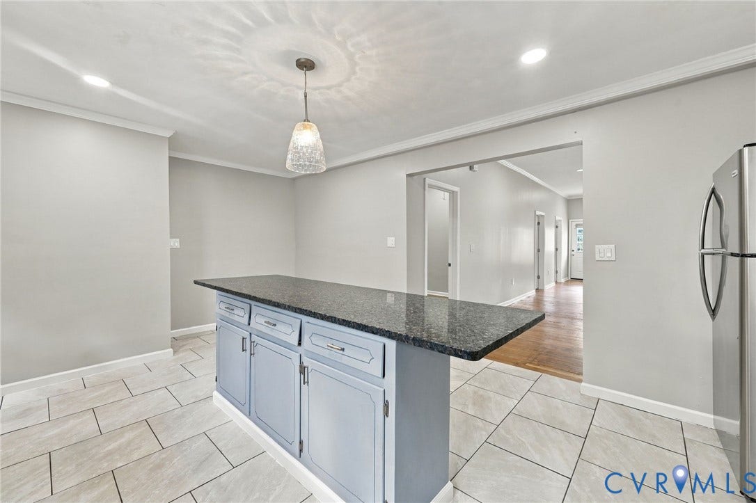 1432 Ferndale Avenue, Petersburg, VA 23803 Kitchen island with a dark countertop, light blue cabinetry, and chrome hardware
