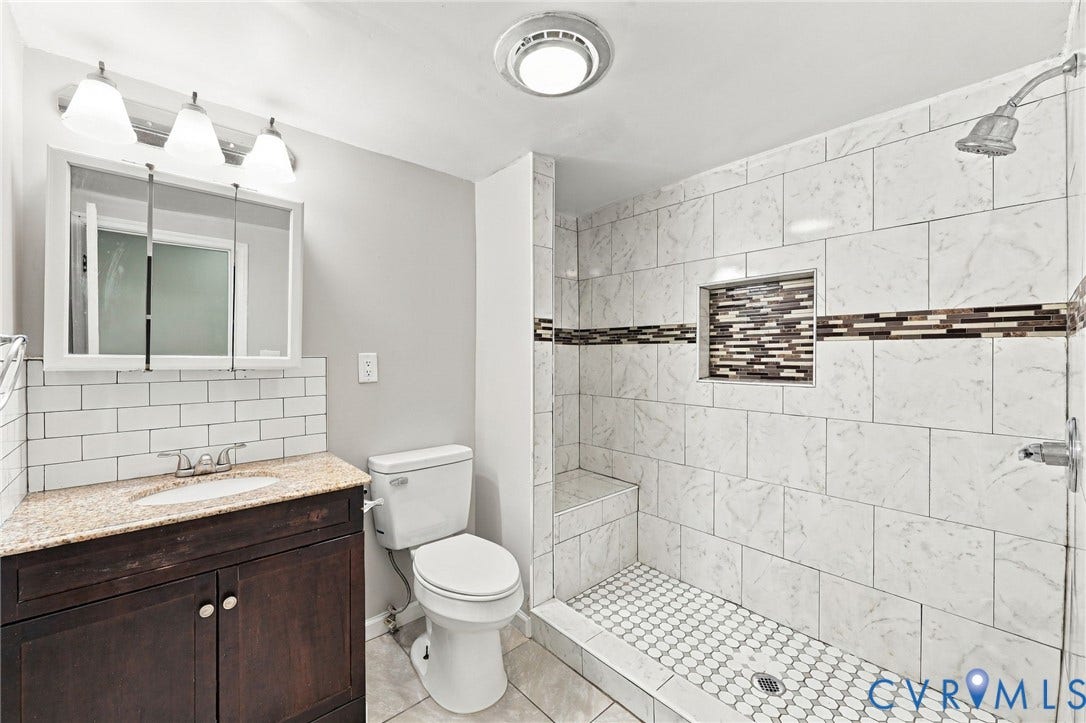 1432 Ferndale Avenue, Petersburg, VA 23803 Walk-in shower with tiled walls, integrated niche, and built-in bench