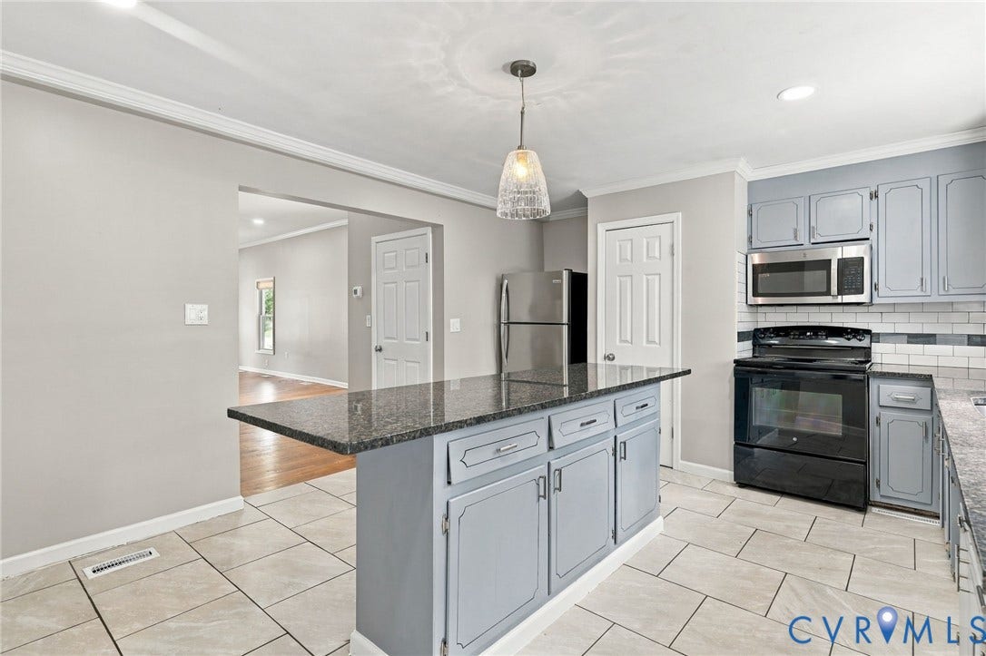 1432 Ferndale Avenue, Petersburg, VA 23803 Kitchen featuring an island with stone countertop, tile flooring, stainless steel appliances, and a tiled backsplash