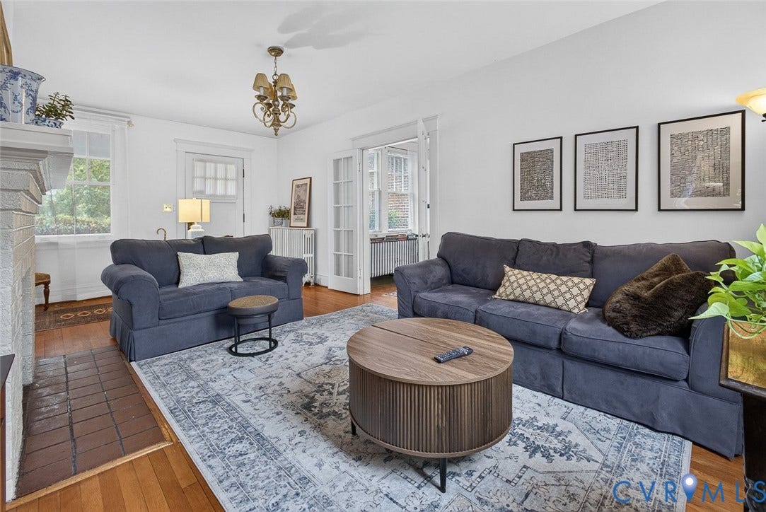 3812 Fauquier Avenue, Bellevue, Richmond, VA 23227 Hardwood flooring, white painted walls, ceiling-mounted light fixture, fireplace with stone surround, and a white paneled door