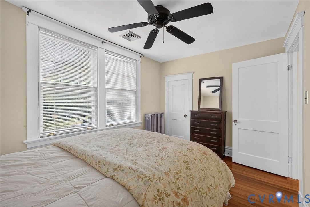 3812 Fauquier Avenue, Bellevue, Richmond, VA 23227 Hardwood flooring, painted walls, two windows with blinds, a ceiling fan, and two panel doors