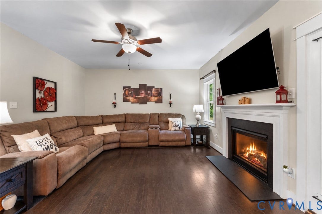 6446 Chestnut Church Road, Mechanicsville, VA 23116 Living space featuring wood-finish flooring, a ceiling fan with integrated lighting, a built-in fireplace, and a white mantel