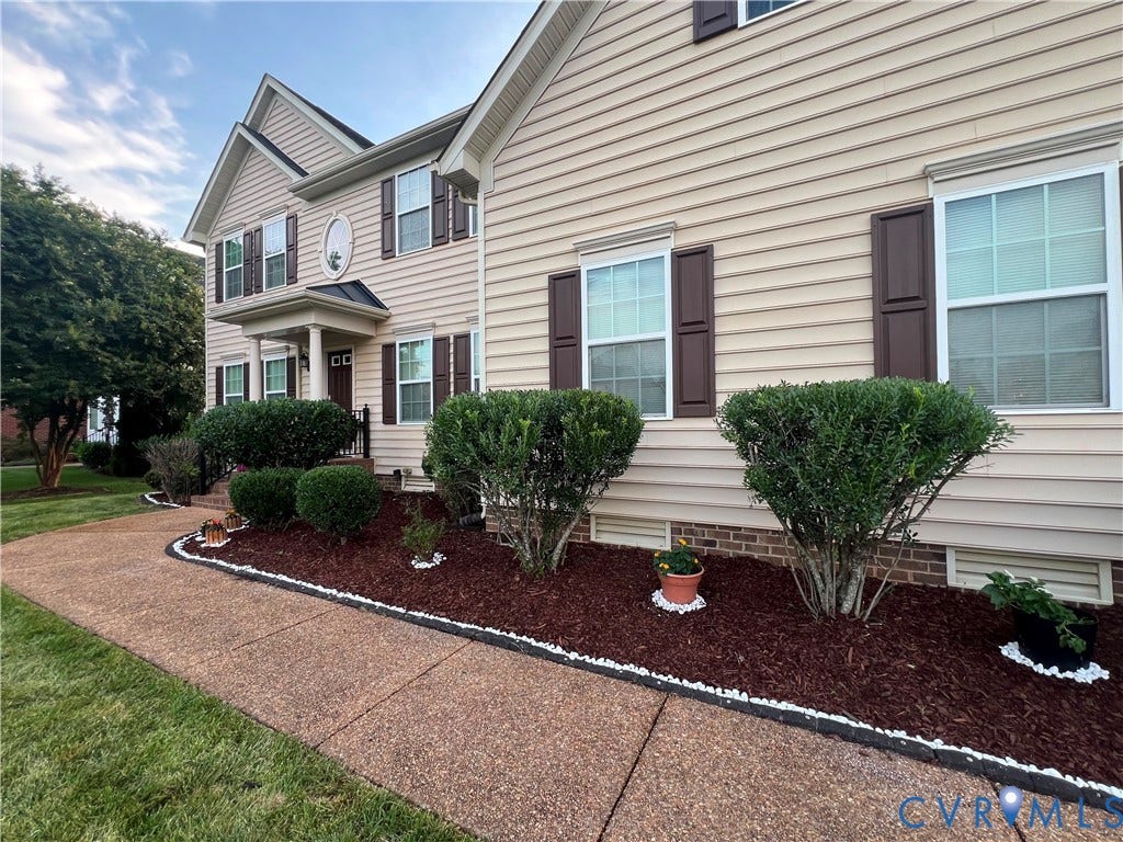 3536 Hunton Ridge Drive, Glen Allen, VA 23059 Two-story residence featuring light-colored siding, dark shutters, and a covered portico entry