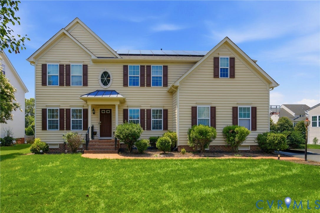 3536 Hunton Ridge Drive, Glen Allen, VA 23059 Two-story residence featuring siding exterior, dark shutters, an oval window accent, solar panels, and a landscaped front yard