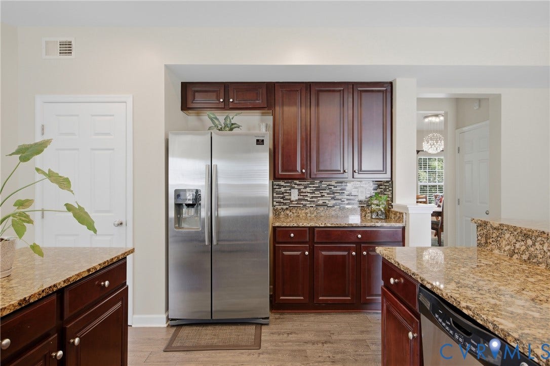3536 Hunton Ridge Drive, Glen Allen, VA 23059 Hardwood-style flooring, rich wood cabinetry, stainless steel appliances, mosaic tile backsplash, and granite countertops
