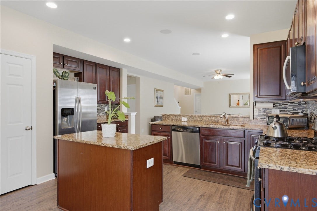 3536 Hunton Ridge Drive, Glen Allen, VA 23059 Kitchen featuring wood-finish flooring, dark wood cabinetry, granite countertops, and stainless steel appliances