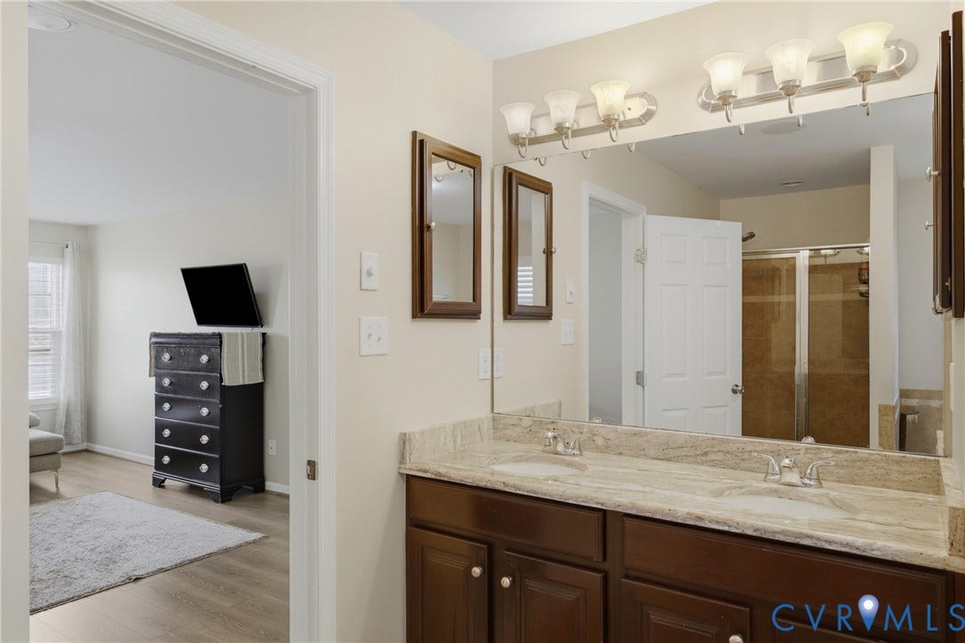 3536 Hunton Ridge Drive, Glen Allen, VA 23059 Dual vanity with undermount sinks, stone countertop, and wood-finish cabinetry