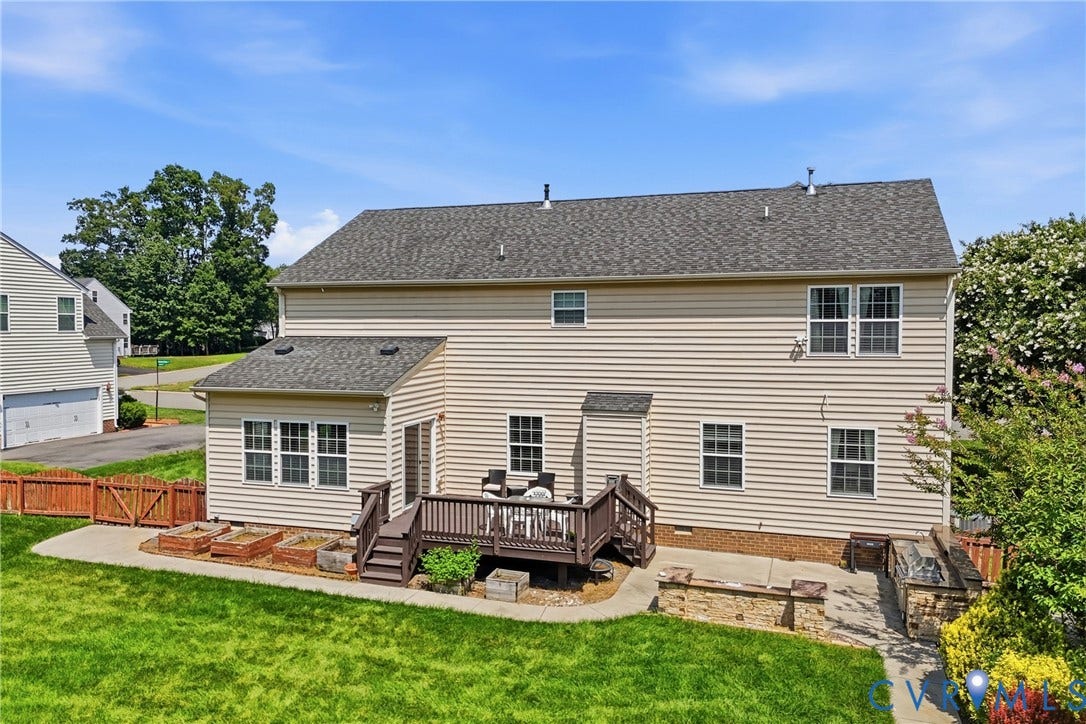3536 Hunton Ridge Drive, Glen Allen, VA 23059 Expansive green lawn with a multi-level deck, stone retaining walls, and raised garden beds