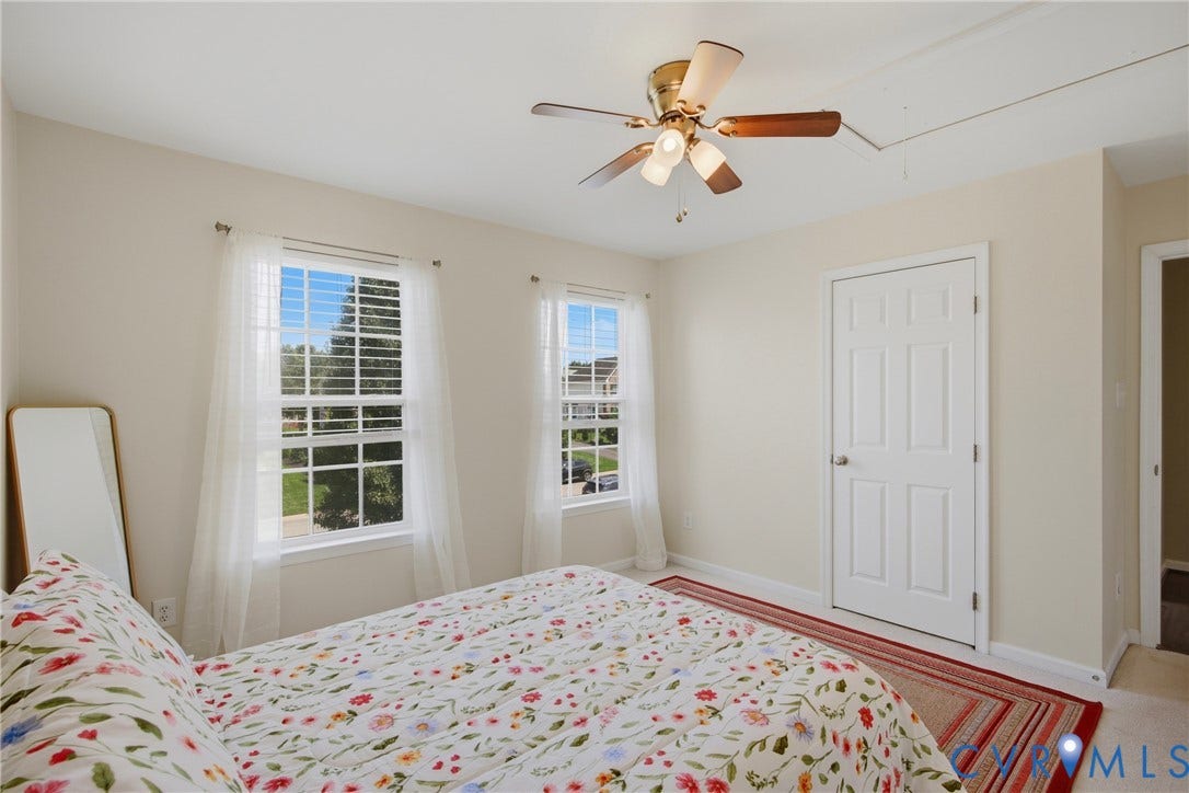 3536 Hunton Ridge Drive, Glen Allen, VA 23059 Two windows with blinds, ceiling fan with integrated lighting, wood-finish flooring, and a paneled door