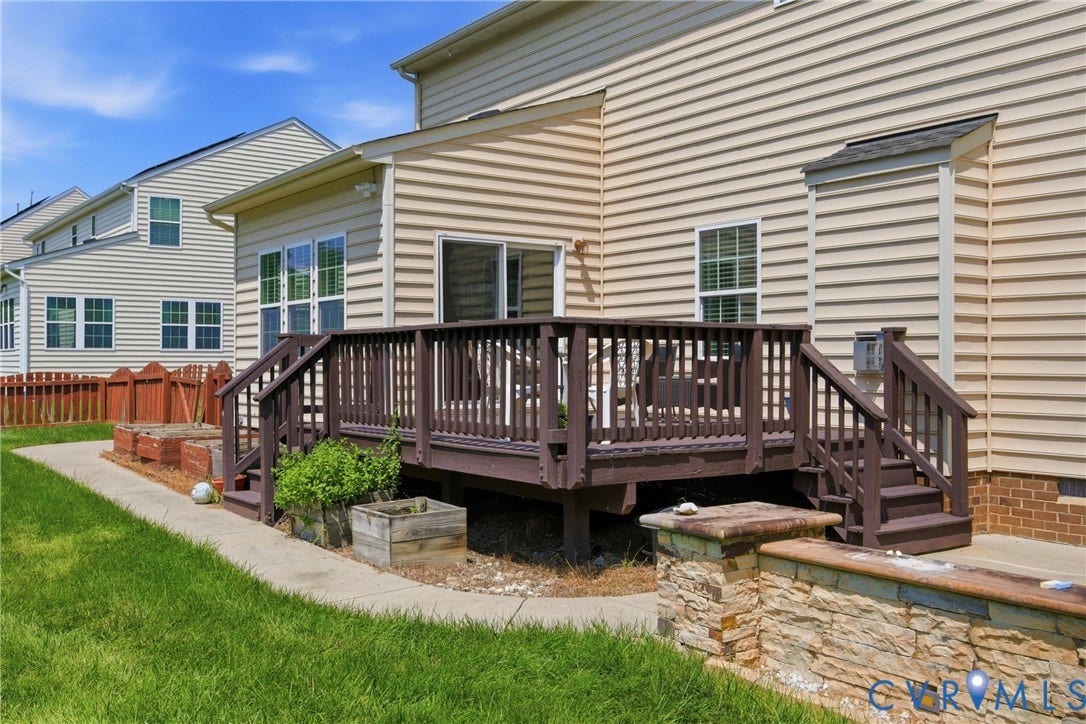 3536 Hunton Ridge Drive, Glen Allen, VA 23059 Spacious rear deck with steps, tan siding exterior, and a stone retaining wall