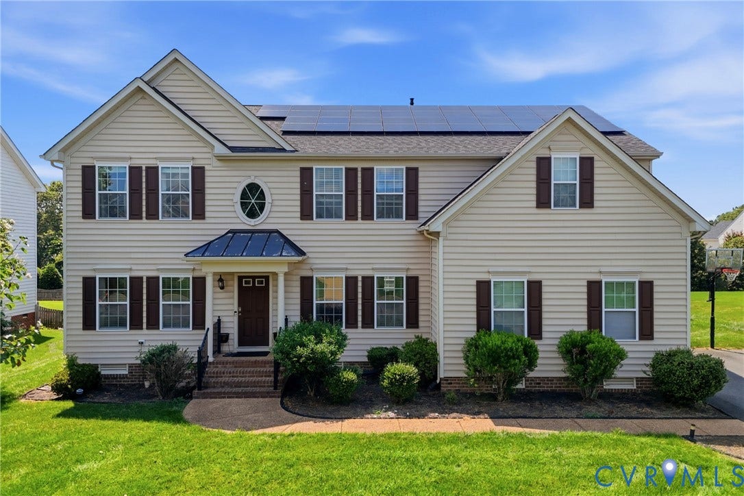 3536 Hunton Ridge Drive, Glen Allen, VA 23059 Two-story residence featuring light-toned siding, dark shutters, an oval window, solar panels, and a gabled roofline