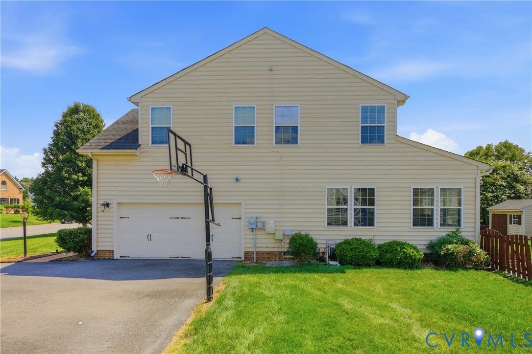 3536 Hunton Ridge Drive, Glen Allen, VA 23059 Two-story exterior with light-colored siding, multiple windows, an attached two-car garage, and a fenced yard