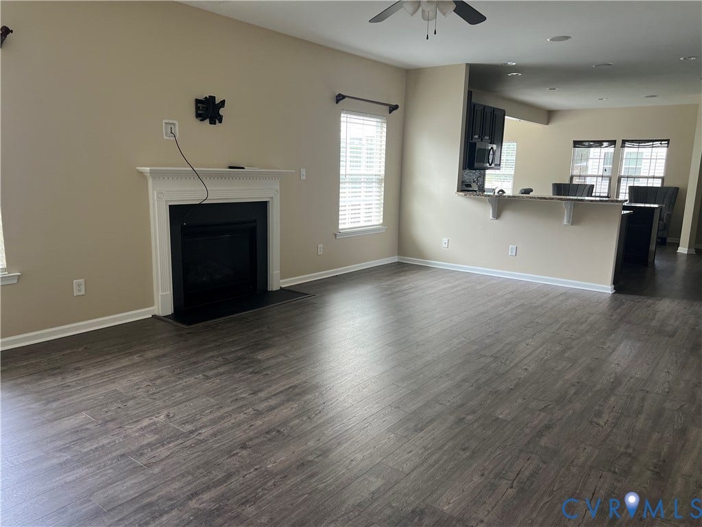 3536 Hunton Ridge Drive, Glen Allen, VA 23059 Living area featuring wood-finish flooring, a fireplace with a white mantel, and a ceiling fan