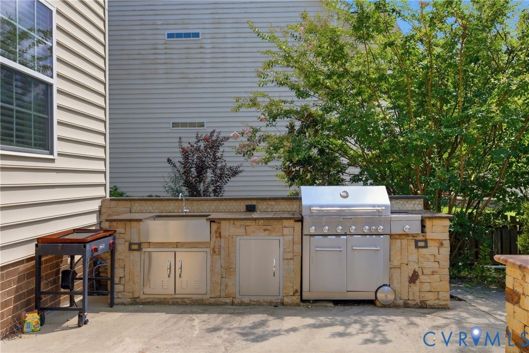 3536 Hunton Ridge Drive, Glen Allen, VA 23059 Outdoor kitchen featuring stacked stone and granite countertops, integrated stainless steel sink, stainless steel storage cabinetry, and a built-in stainless steel grill