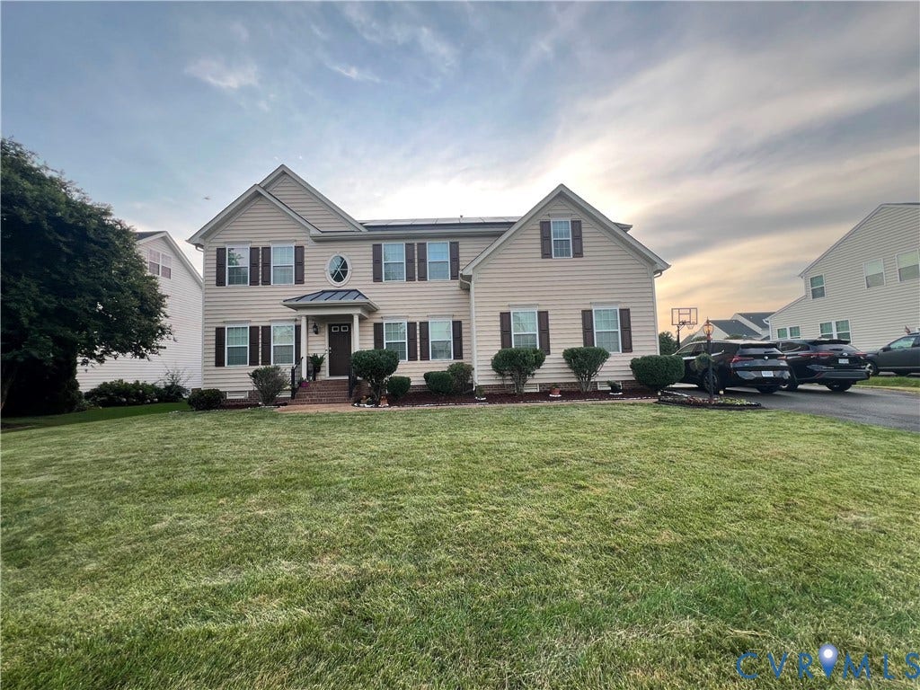 3536 Hunton Ridge Drive, Glen Allen, VA 23059 Two-story residential structure featuring light-colored siding and dark shutters, a front entry with a small portico, an oval window, and a paved driveway