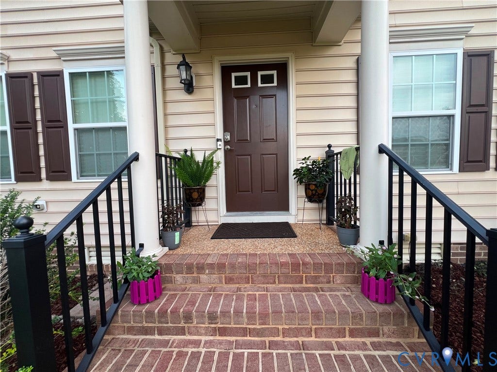 3536 Hunton Ridge Drive, Glen Allen, VA 23059 Brick steps leading to a front entry with a dark-paneled door, flanked by two windows with dark shutters