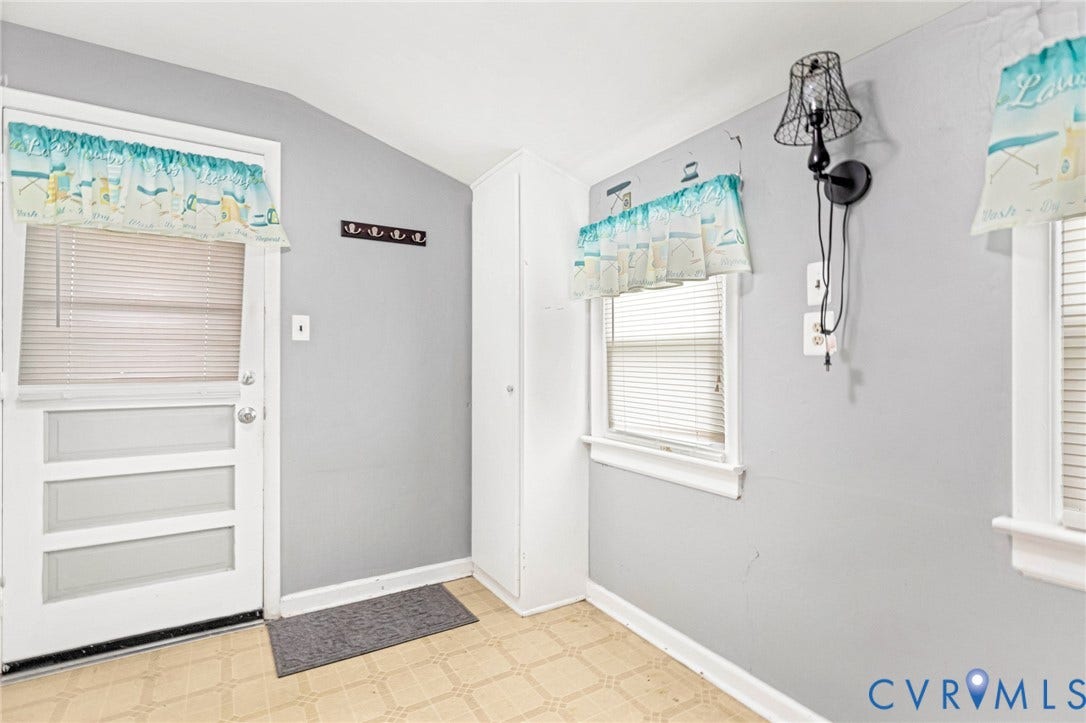 2503 Carlisle Avenue, Henrico, VA 23231 Entryway featuring a white paneled door, built-in storage cabinet, and multiple windows