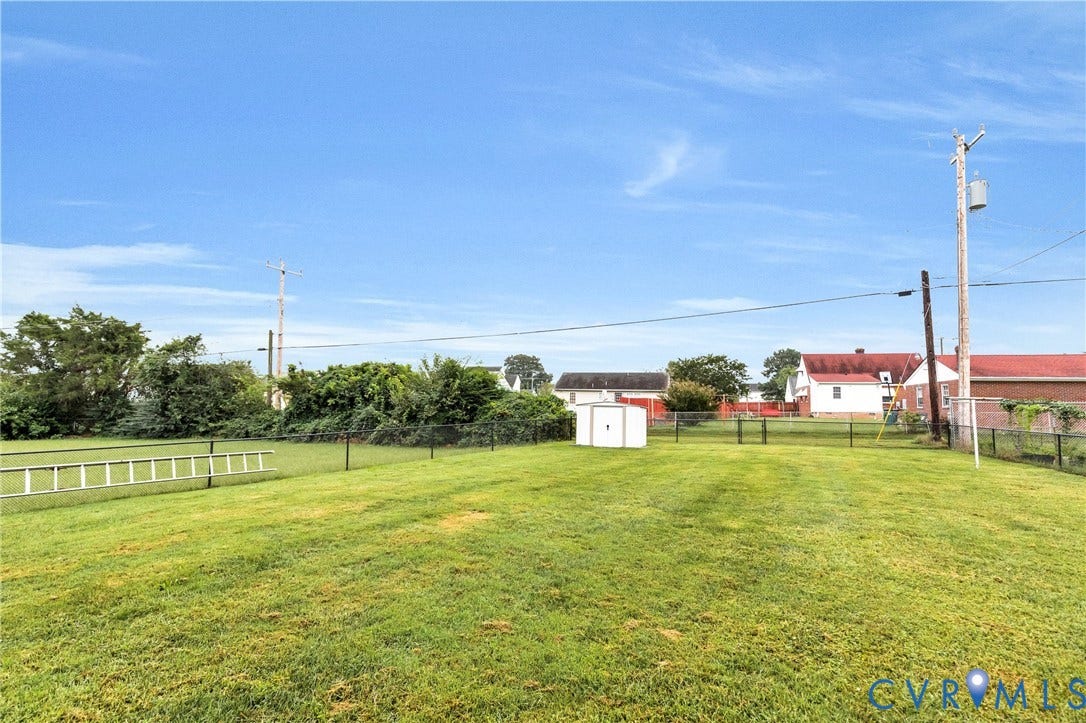 2503 Carlisle Avenue, Henrico, VA 23231 Expansive green lawn with established fencing and a utility shed