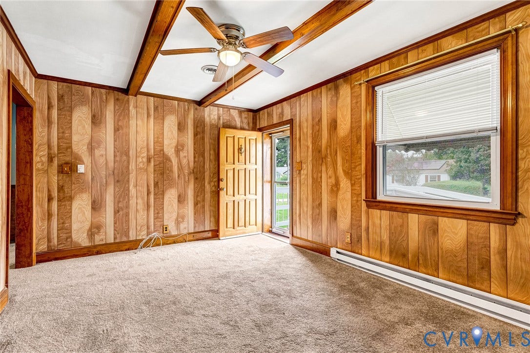 2503 Carlisle Avenue, Henrico, VA 23231 Wood paneling throughout, textured carpeting, exposed wood beams, ceiling fan with integrated lighting, and a paneled entry door