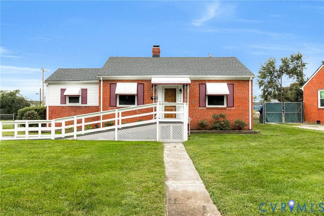 2503 Carlisle Avenue, Henrico, VA 23231 Brick exterior with white siding accents, an accessible ramp, a concrete walkway, and a manicured lawn