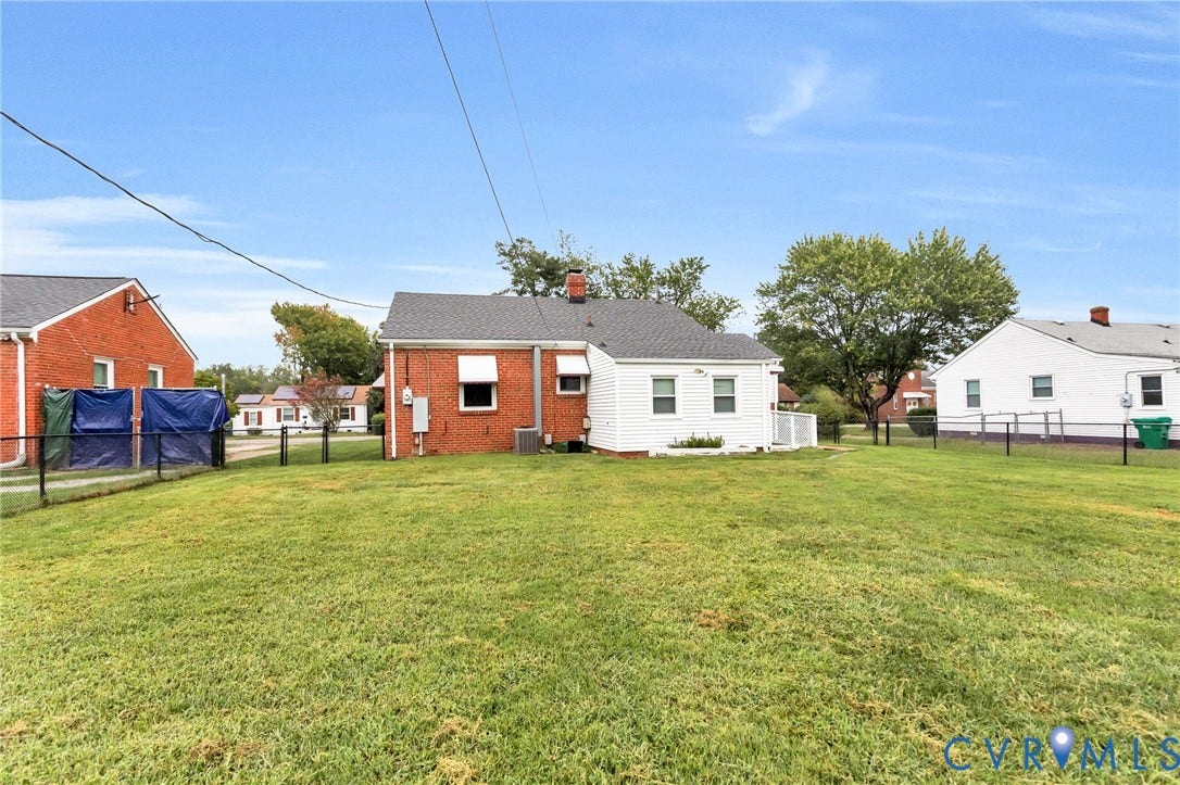 2503 Carlisle Avenue, Henrico, VA 23231 Spacious grounds featuring a manicured lawn and mature tree coverage, with multiple brick and wood-sided residential structures positioned across the property