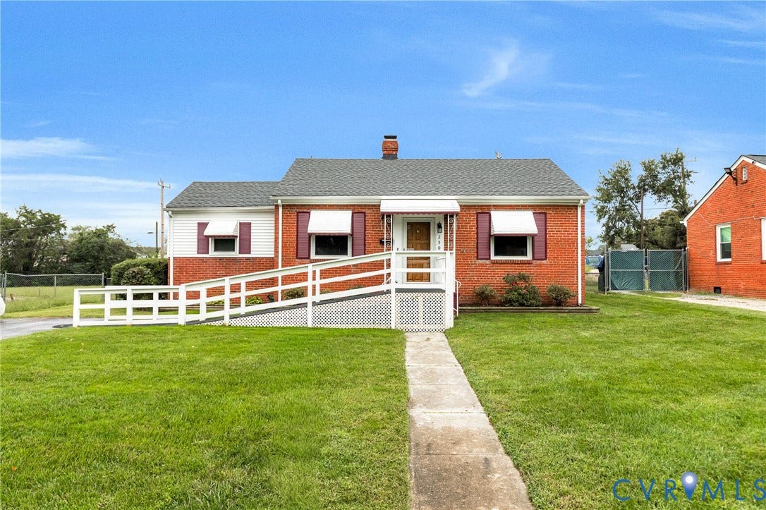 2503 Carlisle Avenue, Henrico, VA 23231 Brick exterior with white vinyl siding accents, a gable roof, and a front porch with a white railing and access ramp