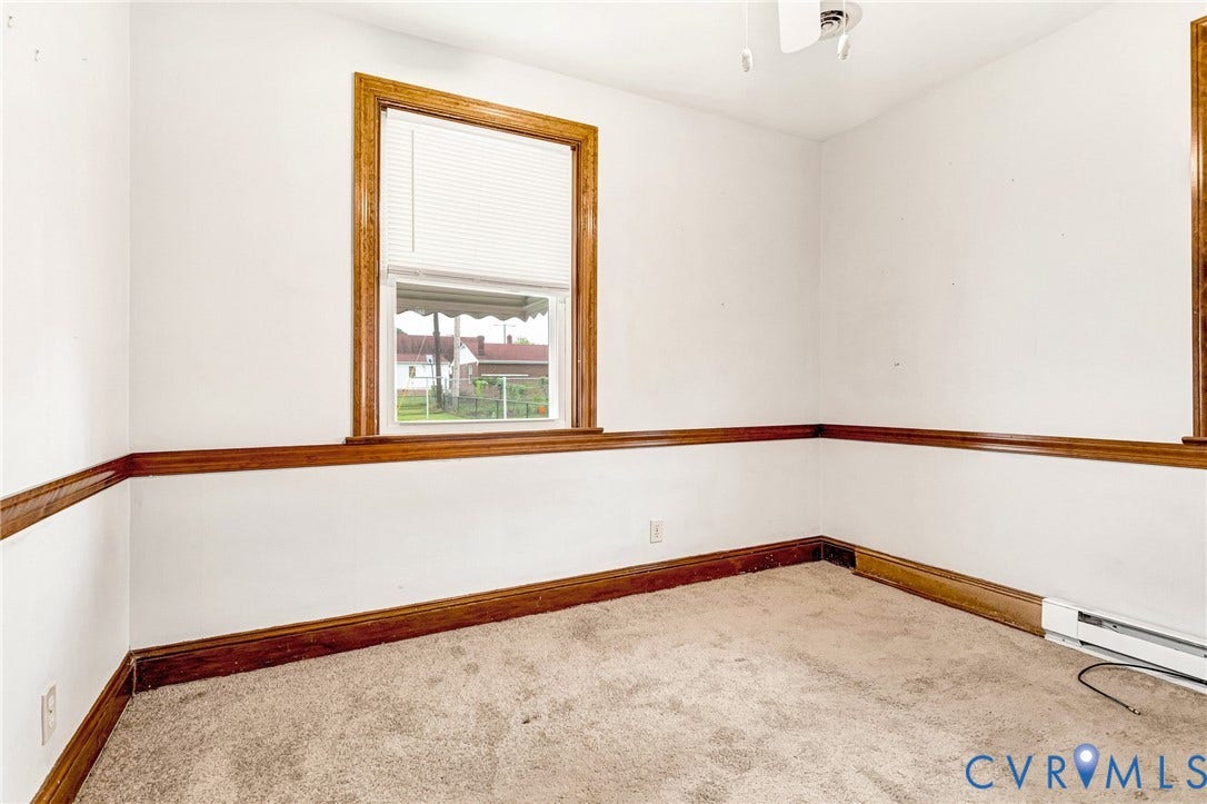 2503 Carlisle Avenue, Henrico, VA 23231 Window with wood trim, wood-finish chair rail, and wall-to-wall carpeting