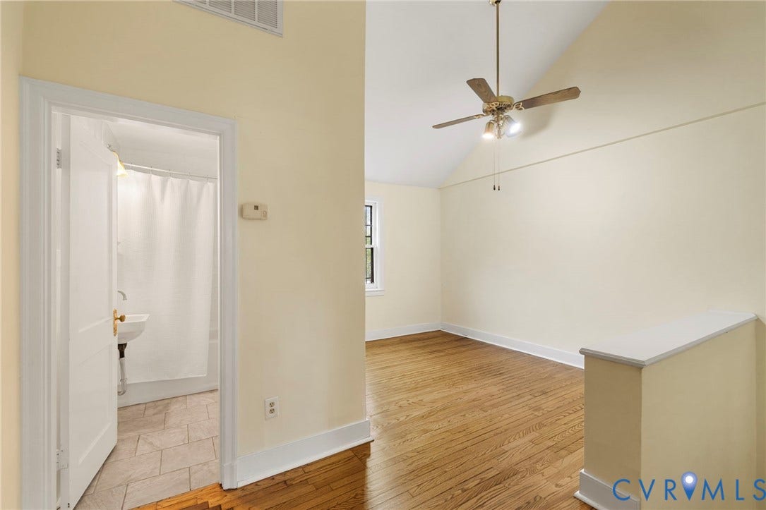 2714 E Broad Street, Church Hill, Richmond, VA 23223 Hardwood flooring, vaulted ceiling, ceiling fan with integrated lighting, window, and wall-mounted sink in the bathroom