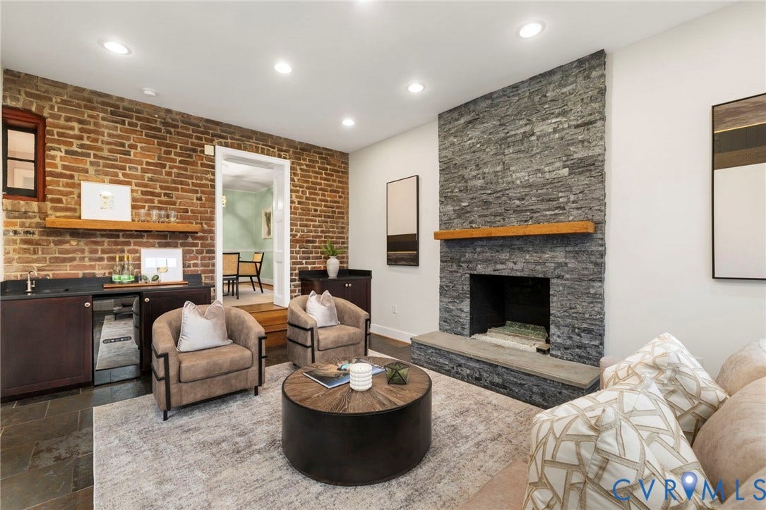 2714 E Broad Street, Church Hill, Richmond, VA 23223 Exposed brick wall, recessed lighting, stone-clad fireplace with wood mantel, built-in wet bar with sink, and dark-toned flooring