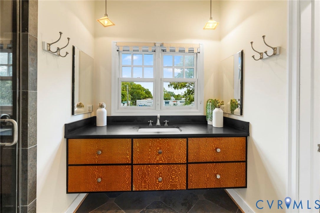 2714 E Broad Street, Church Hill, Richmond, VA 23223 Floating vanity with textured wood-finish drawers and a dark countertop