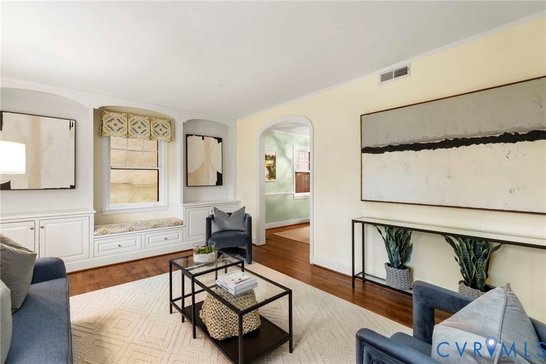 2714 E Broad Street, Church Hill, Richmond, VA 23223 Built-in window seat with storage, white cabinetry, hardwood flooring, and arched entryway