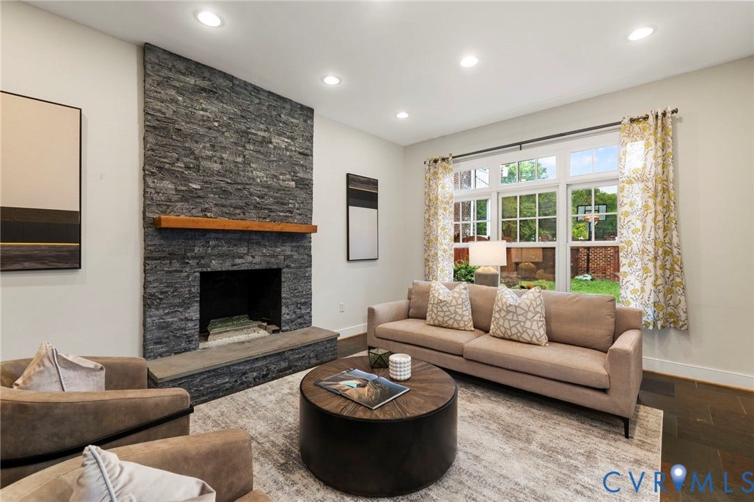 2714 E Broad Street, Church Hill, Richmond, VA 23223 Stone-faced fireplace with a wood mantel, recessed lighting, expansive windows, and wood-finish flooring