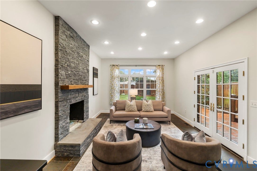 2714 E Broad Street, Church Hill, Richmond, VA 23223 Stone-clad fireplace with a wood mantle, recessed lighting, double French doors, large window, and dark wood-finish flooring