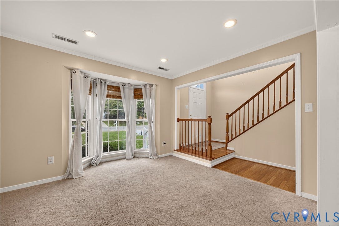 9516 Hungary Woods Drive, Henrico, VA 23060 Bay window with multiple panes, recessed ceiling lighting, light-toned wall paint, staircase with wood-finish railing, and wood-finish flooring