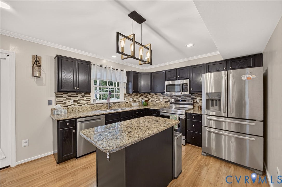 9516 Hungary Woods Drive, Henrico, VA 23060 Kitchen featuring dark wood-finish cabinetry, granite countertops, a mosaic tile backsplash, island, and wood-finish flooring