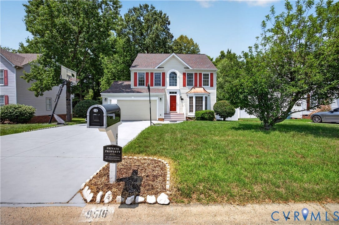 9516 Hungary Woods Drive, Henrico, VA 23060 Traditional-style residence featuring a cream-colored exterior, red shutters, and a prominent bay window with a copper-tone roof