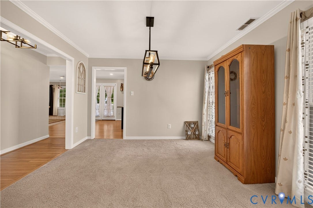 9516 Hungary Woods Drive, Henrico, VA 23060 Carpeted flooring, crown molding, window treatment and a modern rectangular chandelier